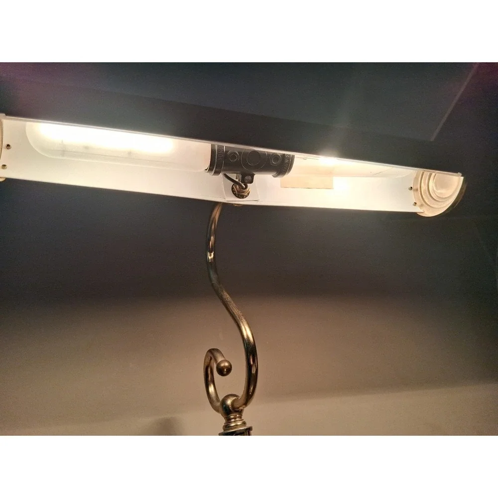 Vintage brass tone desk lamp with elegant scroll arm and classic piano light